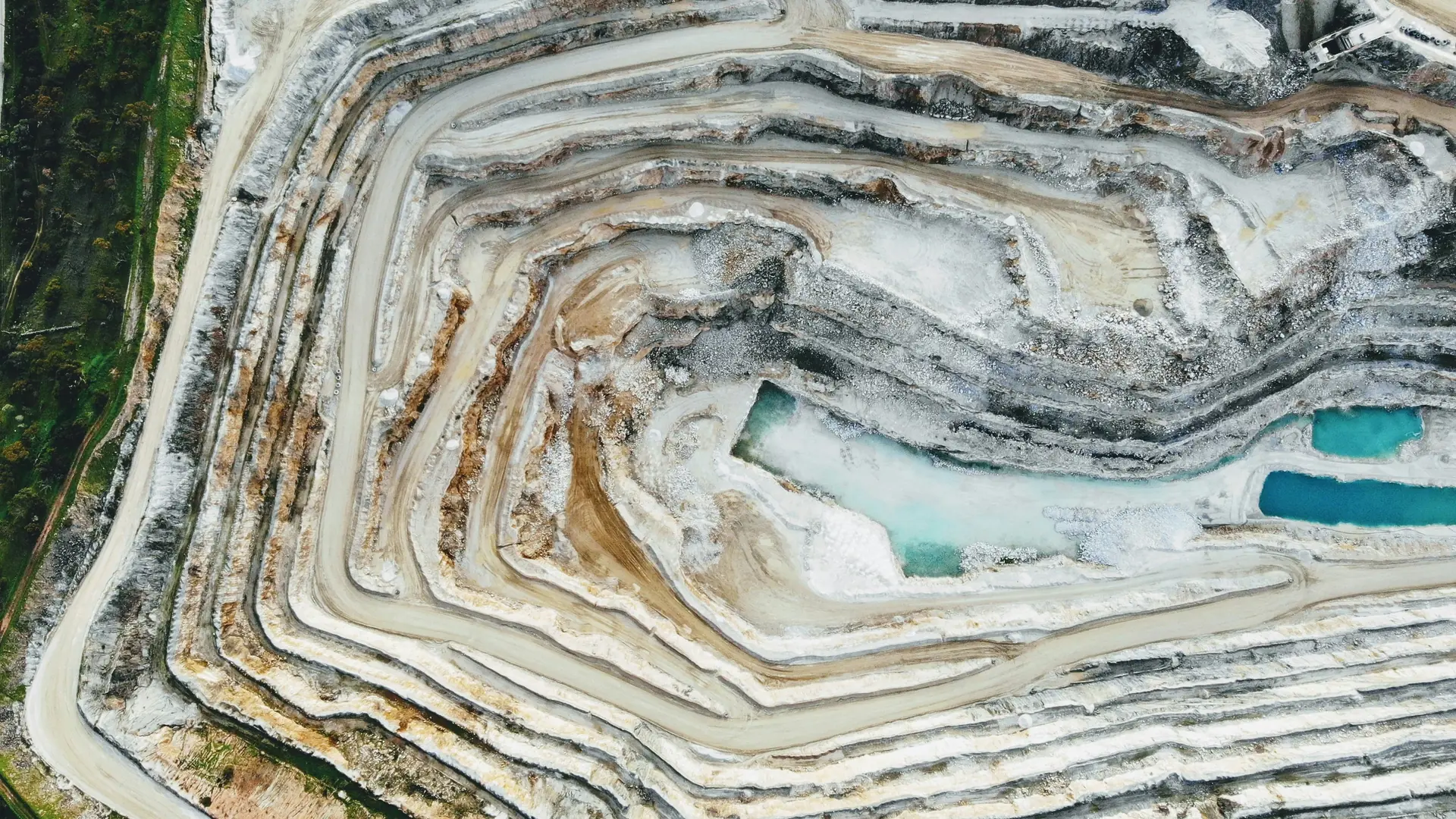 Open pit mine showing geological strata and development infrastructure